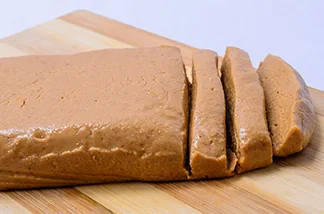 Traditional peanut paste sliced on a wooden board